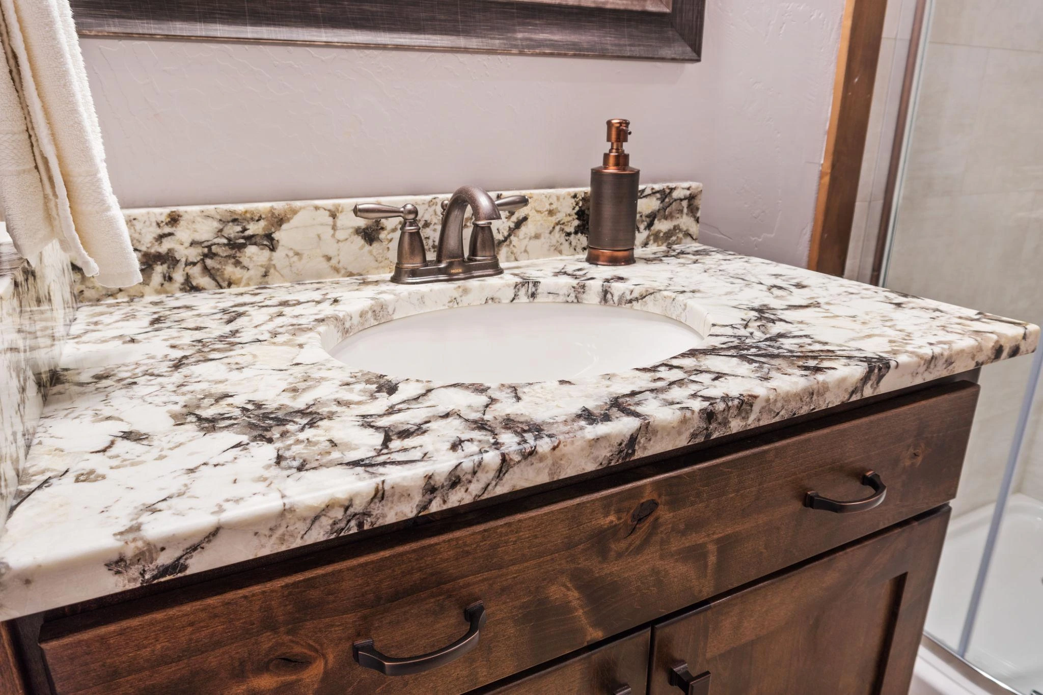 Bathroom vanity with marble countertop, natural veining, and undermount sink in a classic luxury design
