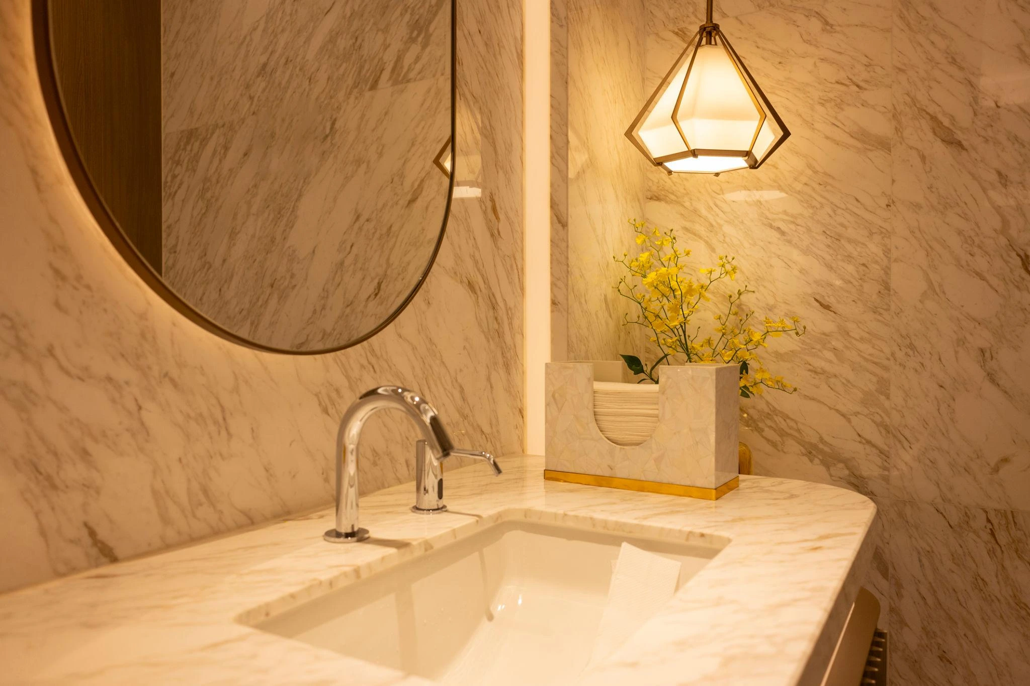 Bathroom vanity with quartzite countertop, natural stone surface, and integrated sink in a warm luxury setting